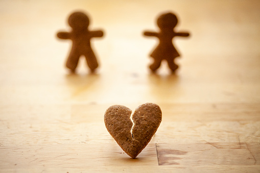 View of gingerbread man and woman with broken heart.