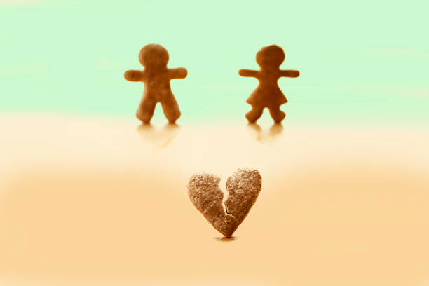 View of gingerbread man and woman with broken heart.