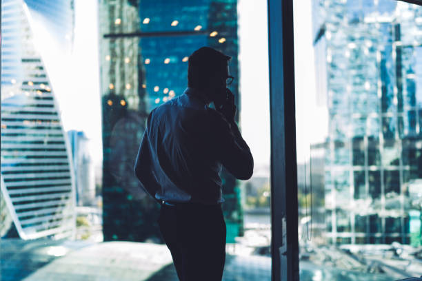 istock Faceless manager talking to colleague on phone in office 1445812203