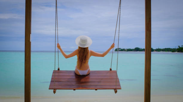 istock Woman in a bikini is on swings. 1445815356