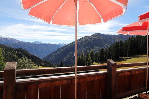 view of the mountains from a terrace with parasols