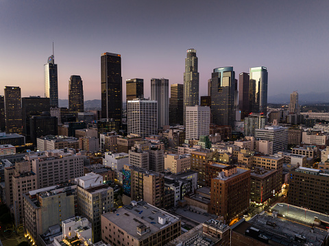 Aerial view of Downtown Los Angeles at dusk, looking across the historic core towards skyscrapers in the financial district.