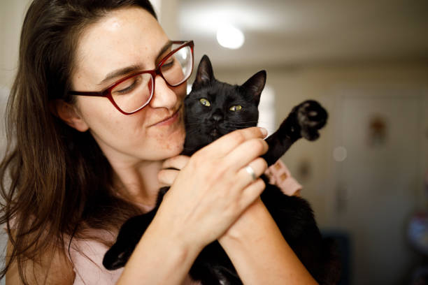 istock Woman and her disabled black kitten 1445818478