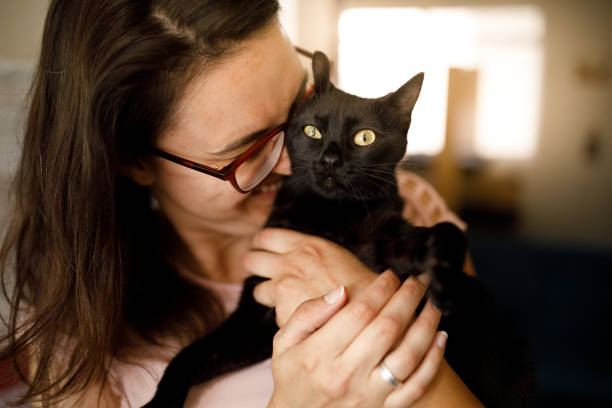 istock Woman showing love for her black cat 1445818512