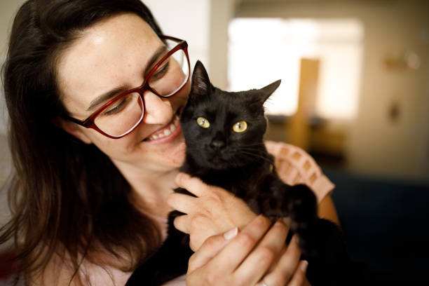 istock Woman and her black kitten 1445818513