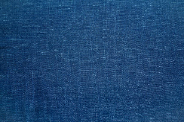 istock dark blue linen fabric texture background. Navy blue cloth textile background. Draped raw organic cloth pattern 1445818934