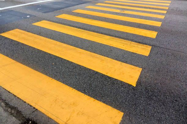 Pedestrian yellow zebra crossing sign on city street stock photo