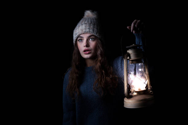 istock A girl illuminates her way with a lamp. 1445820735