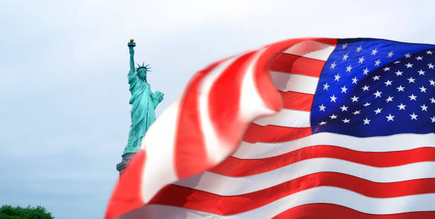 istock Statue of Liberty and American flag 1445820919