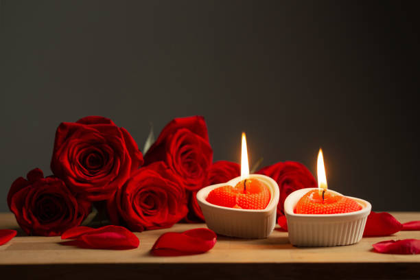 istock red roses with burning candles on dark background 1445821000
