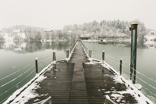 Wooden Path Over The Lake Covered in Snow