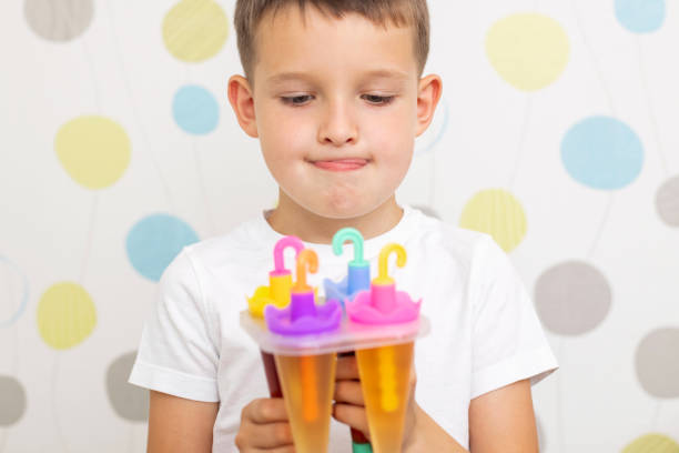 istock Child making ice cream from fruit juice on table at home 1445822517