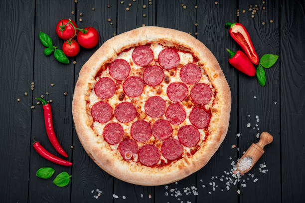 istock Tasty pepperoni pizza and cooking ingredients tomatoes basil 1445823852