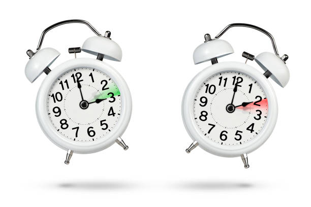 istock Change time. Winter and summer time concept isolated on white background. Change the time in spring and autumn, a white alarm clock indicates a change in time one hour ago, one hour ahead. 1445824376