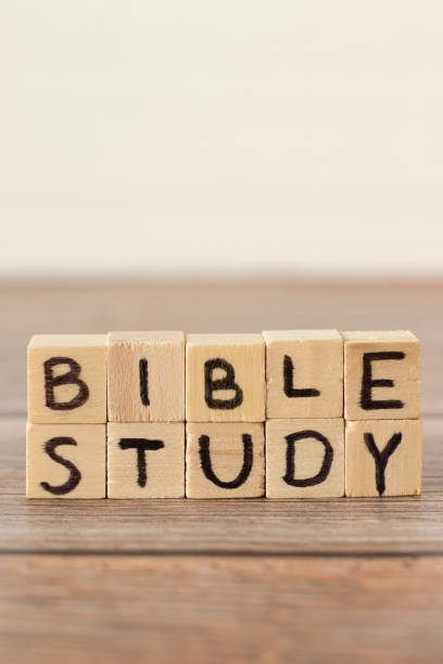 istock Bible study handwritten text on wood cubes on rustic table with white background, vertical shot, copy space 1445828472