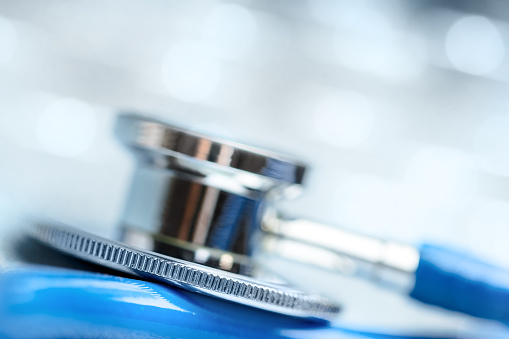 Close-up of a stethoscope on a defocused bokeh background. Shallow depth of field, space for copy.