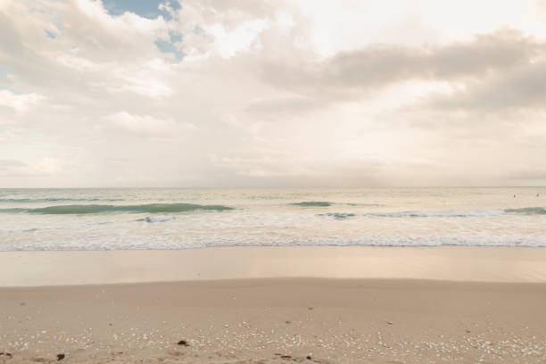 istock Teal Ocean Waves Sweeping Ashore an Empty Shoreline at Sunset in Singer Island, Florida 1445832610