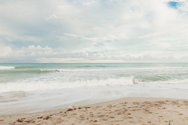 istock Teal Ocean Waves Sweeping Ashore an Empty Shoreline at Sunset in Singer Island, Florida 1445833345