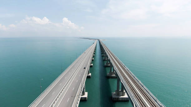 aerial view along the long beautiful bridge above turquoise sea. action. flying above bending bridge with driving cars. - key west imagens e fotografias de stock
