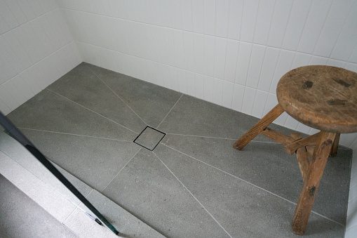 Modern shower drain with tile and wood stool