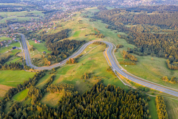 Aerial view of a cars driving down country road autumn landscape.