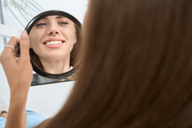 istock Dental clinic client admiring her clean white teeth 1445836416