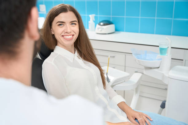 istock Joyful female patient talking to stomatologist during appointment 1445836546