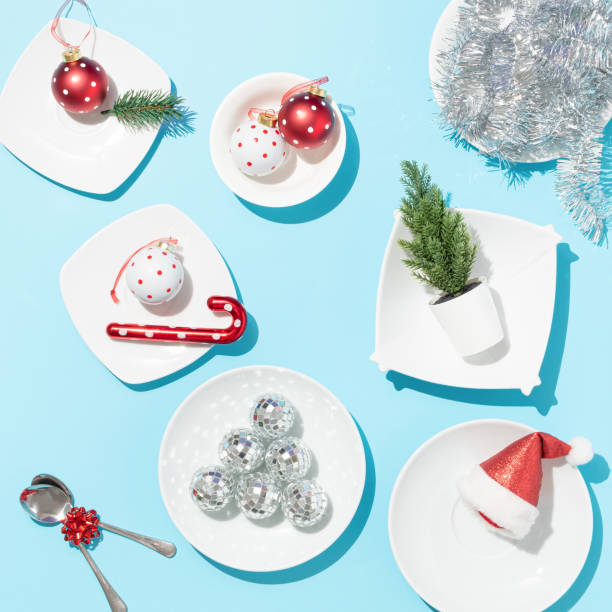 istock Christmas table setting surreal idea. Christmas decoration on white plates creative composition. Festive season aesthetic. New Year or Christmas celebrating concept. Art direction. 1445836824