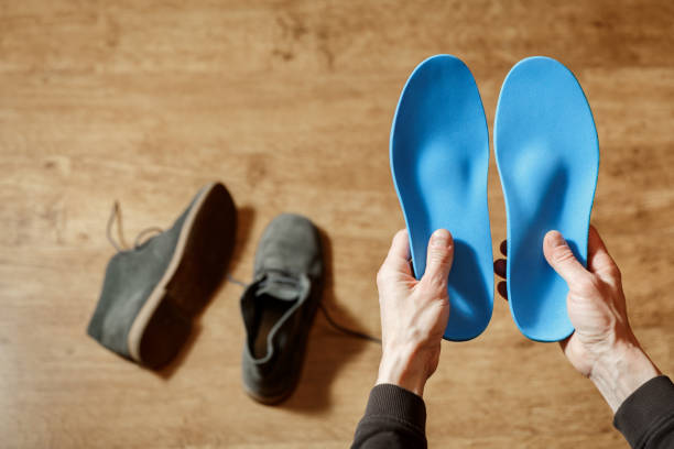 ustom orthopedic insoles in a male hands. Man holding new cusmom insoles. ustom orthopedic insoles in a male hands. Man holding new cusmom insoles. Feet recreation medicine concept pes planus stock pictures, royalty-free photos & images