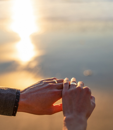 Sunset engagement ring, proposal, gay men, Close up of hands