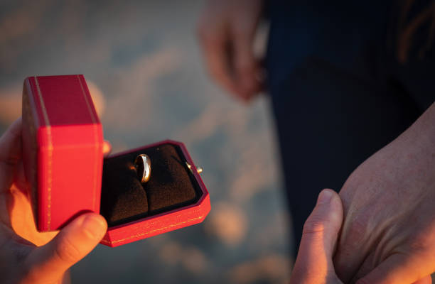 istock Sunset engagement ring, proposal, gay men on beach with copy space 1445838792