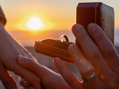 Sunset engagement ring, proposal, gay men on beach with copy space