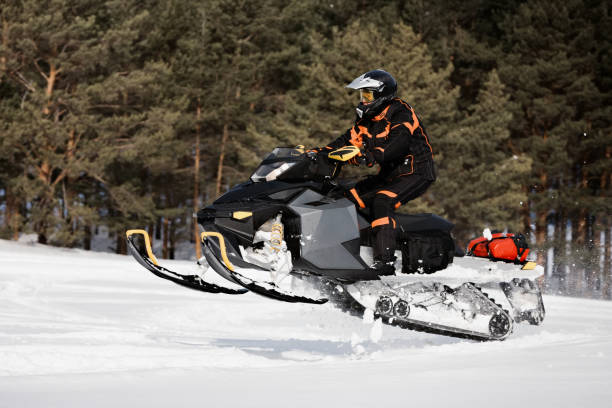 istock In deep powder snowdrift snowmobile rider driving fast. 1445839790