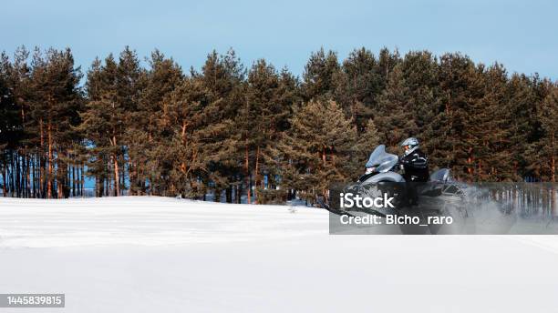 In Deep Powder Snowdrift Snowmobile Rider Driving Fast Stock Photo - Download Image Now