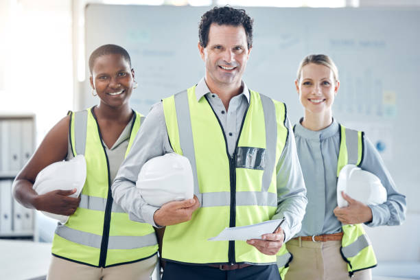 istock Architecture, diversity and engineering leader with a team or group of workers ready to start building a project. Smile, trust and construction manager with happy designers for teamwork in an office 1445839984