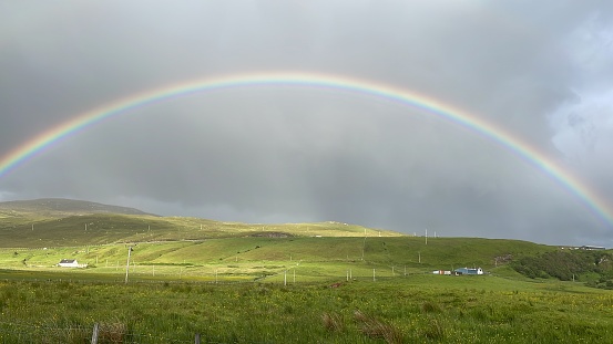 A stunning rainbow over the hills in the Scottish Highlands