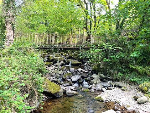 A beautiful, quiet bridge stands over a stream of gushing water near Llanfairfechan, North Wales