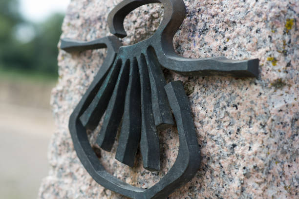 Milestone with a shell, the symbol of Santiago way. Spain