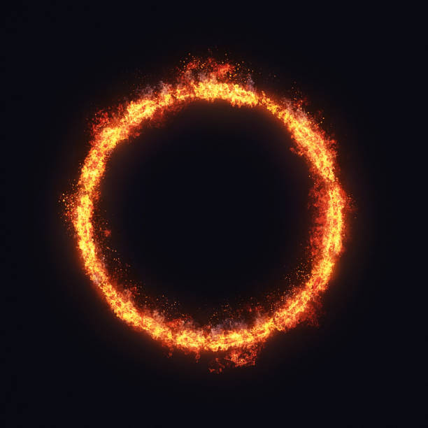 Ring of fire: Brightly burning hoop engulfed by flames, on a dark background stock photo