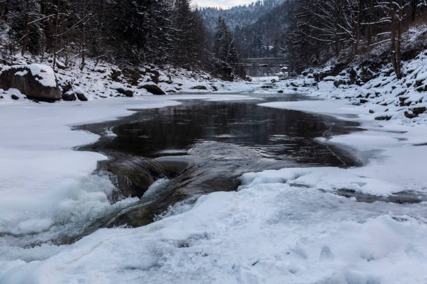 istock Ice formations on a frozen river covered with snow 1445846885