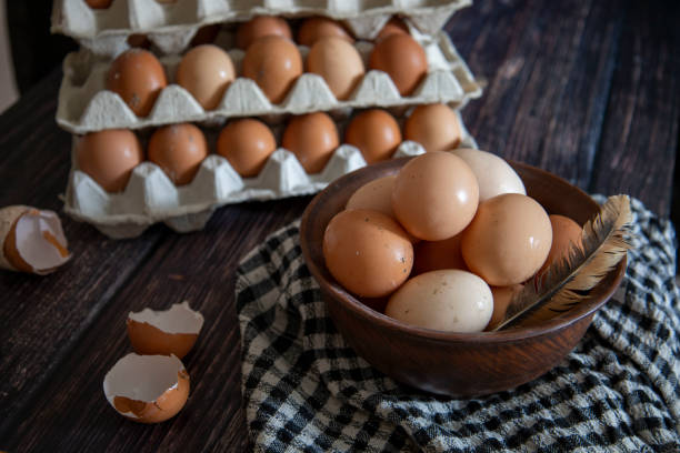 istock Chicken eggs in a clay plate and trays on the table 1445848193