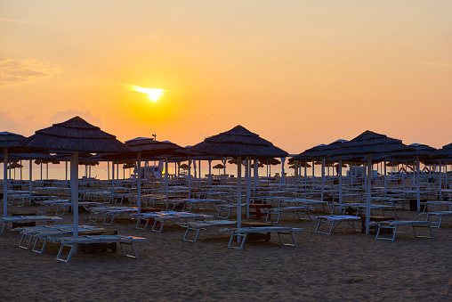 Umbrellas and sunbeds on the beach of Rimini in Italy