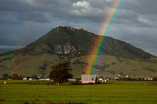 Rainbow over pink barn