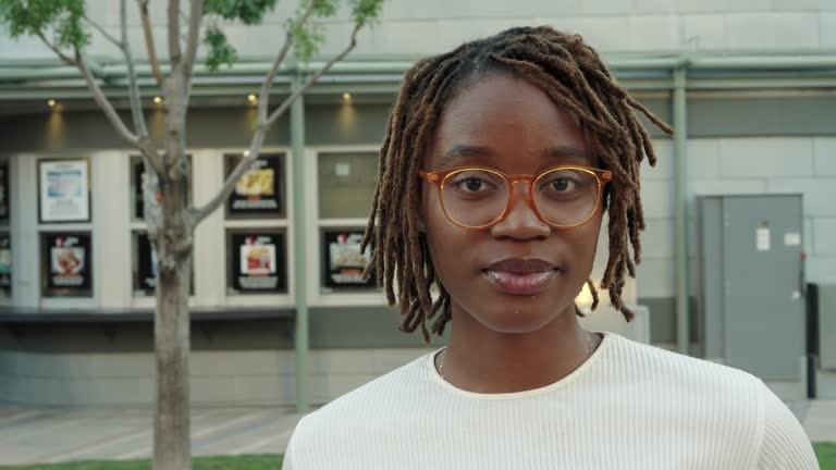 Beautiful African American Woman in her Twenties Posing and Looking Away from Camera in a Public Park in El Paso Texas at Dusk