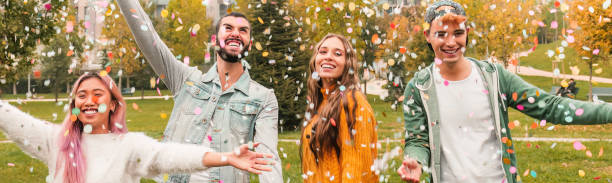 istock Multiracial teenage ersasmus student group celebrates with confetti. 1445854874