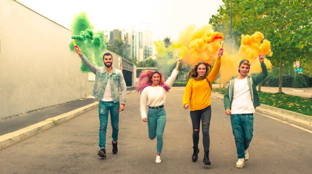 istock multi-ethnic teenage ersasmus student group celebrates with smoke bomb. 1445854883