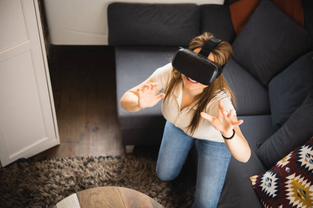 istock Woman using VR glasses at home 1445857034