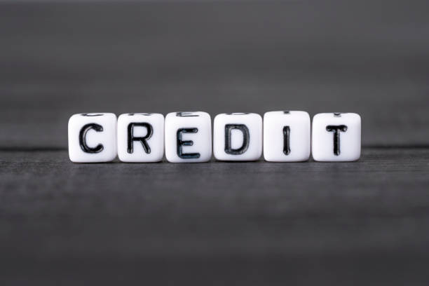 istock CREDIT word composed of white cubes on black background 1445857315