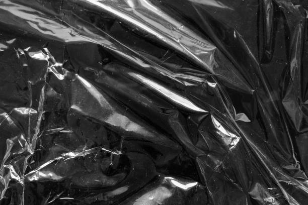 istock transparent plastic bag film wrap overlay texture on black background 1445857429