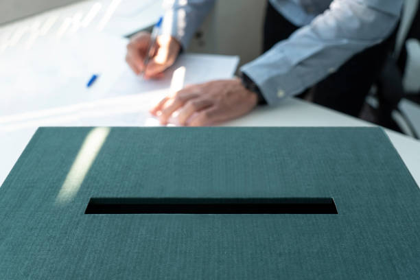 Voting box and election image. a man votes at a polling station